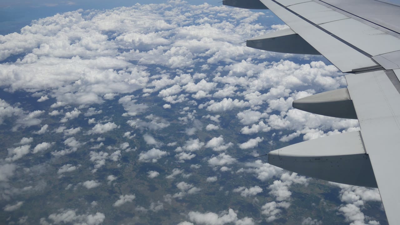 An aeroplane wing above the clouds