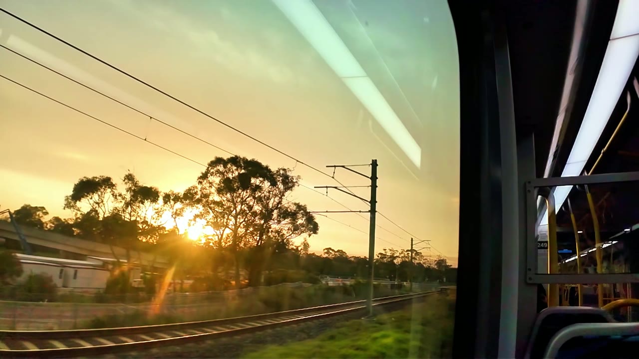 A golden sunset seen from a train window